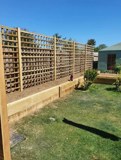 Newly installed wooden fencing with planters at the bottom of them