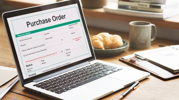 open laptop on table showing a purchase order