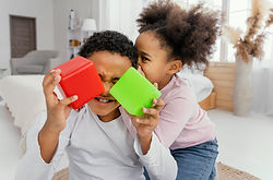 front-view-two-siblings-playing-with-cubes.jpg