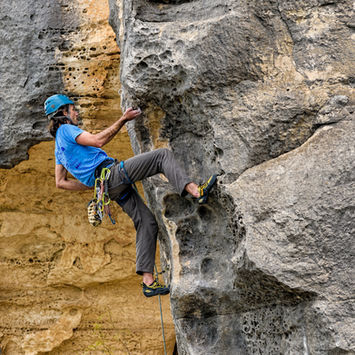 Climber ascends challenging rock face
