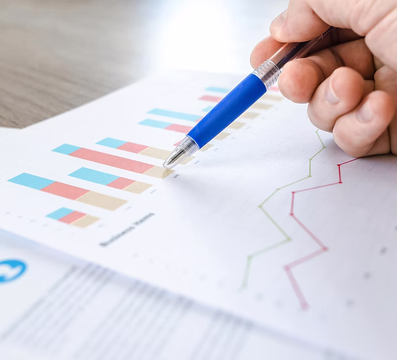 Business professional analyzing financial charts, representing improved speed and scalability for ServiceNow platform teams in finance