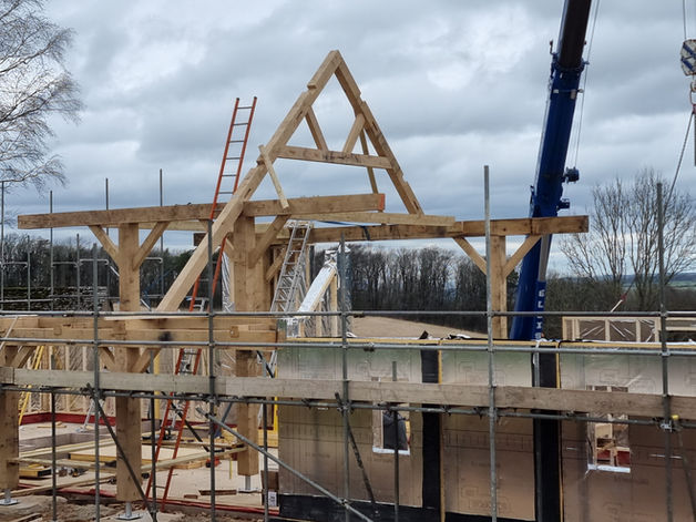 Timber frame construction with crane and scaffolding