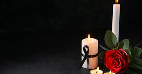 front-view-burning-candle-with-red-flower-dark-surface
