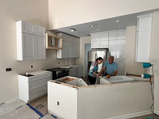 Kitchen renovation in progress with island construction and lighting installation, Charlotte NC.