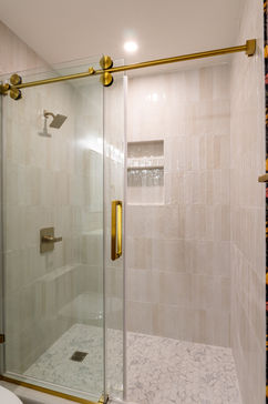 Glass shower with gold hardware and tiled surround, South Charlotte bathroom remodel.