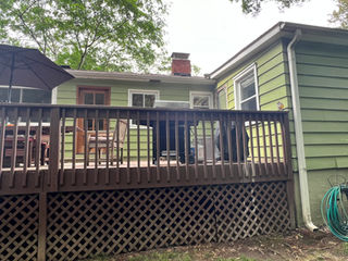 Back deck renovation with black railing and raised platform, South Charlotte exterior remodel