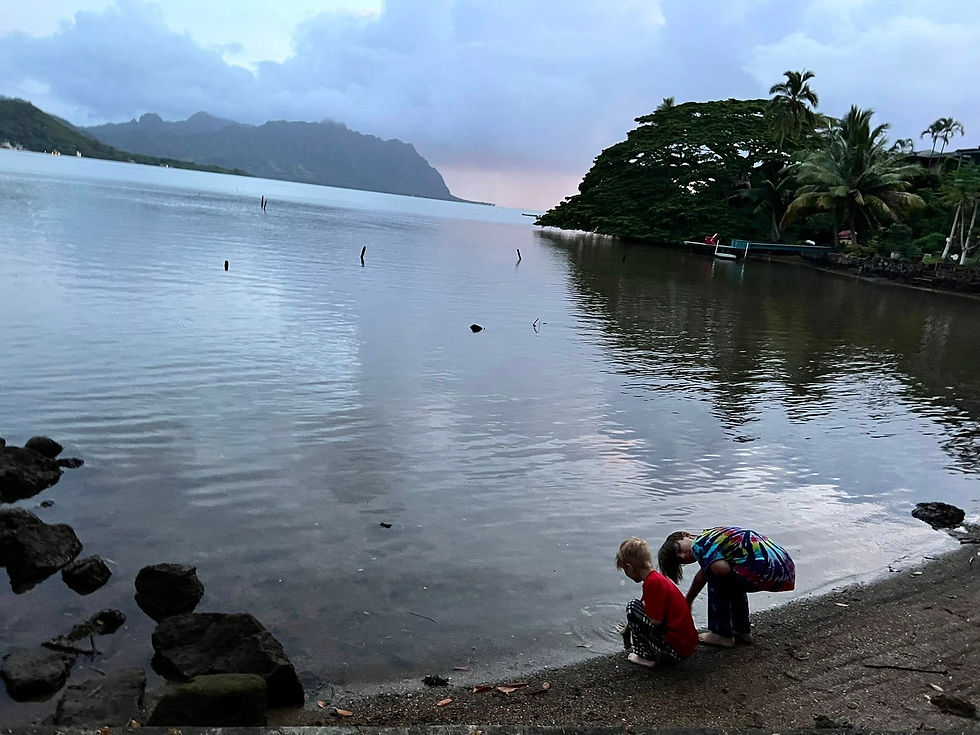 Both boys playing in the water outside of our two-bedroom room at Paradise Bay Resort