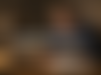 Small business owner using a laptop in a workshop office, focused on running and growing the business