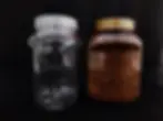 Thumbnail: Two cosmetic plastic jars, one empty, one with brown contents