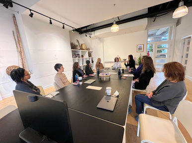 Collaborative meeting at a long table in a light-filled room at ALTAR Chicago
