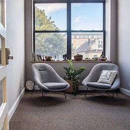 Cozy reading nook with modern lounge chairs and spiritual décor in ALTAR’s Logan Square event venue