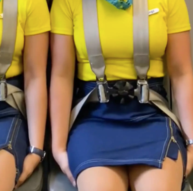 Why do flight attendants sit on their hands during take off and landing?