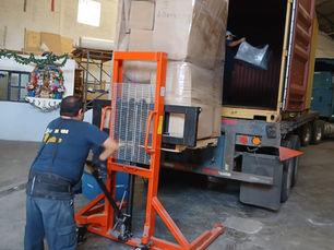 International moving operation with specialized staff unloading a moving truck, representing professional packing, logistics coordination, and secure global relocation services by Logimpex.