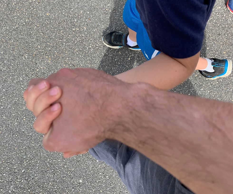Matt holds hands with a student