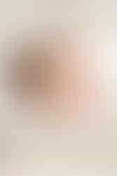 Newborn baby resting peacefully in parents’ arms during an Upper St. Clair lifestyle session