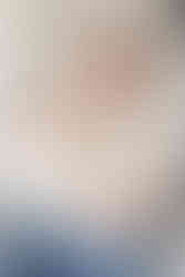 Dad holding his newborn baby in a cozy South Hills family room setting