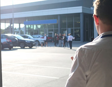 Firefly_daytime at a car dealer ship, view is from the street looking at the dealer parkin