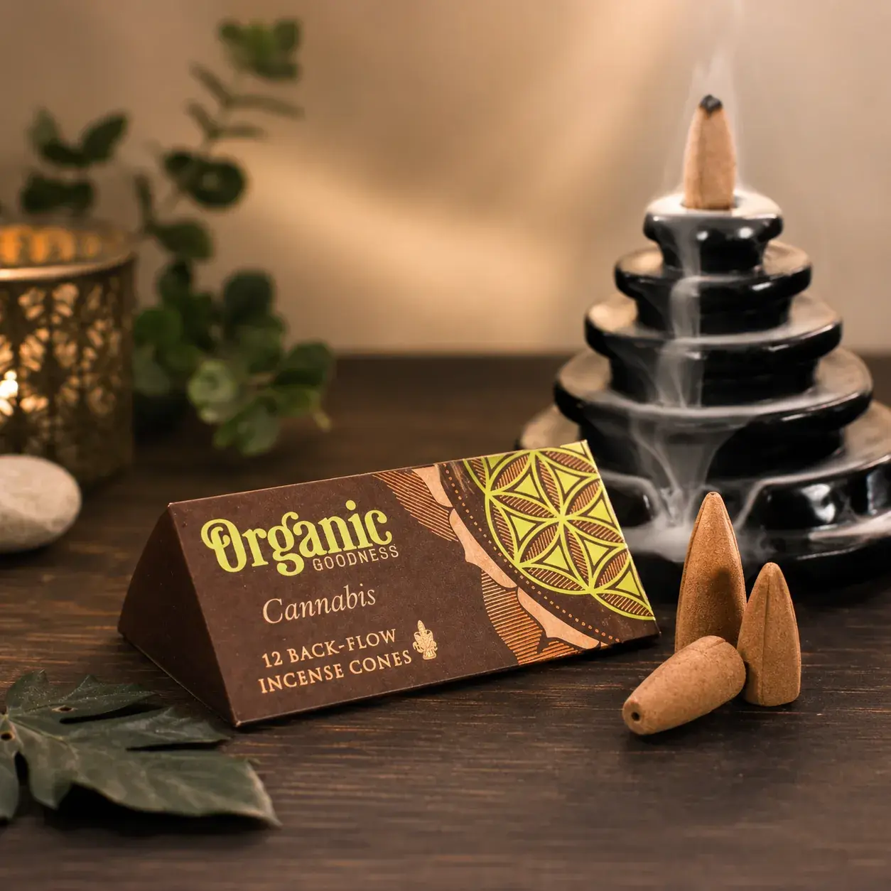 Organic Goodness cannabis backflow incense cones beside a black waterfall burner