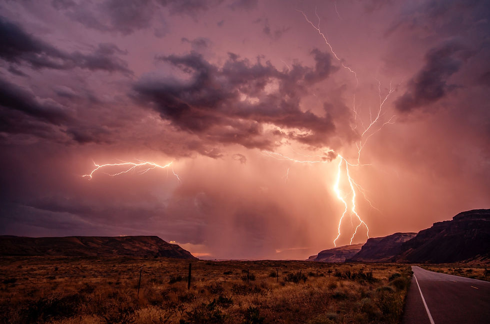 Pink and purple lightning storm over the desert