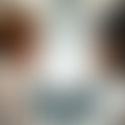 executives looking through transparent wall at employees