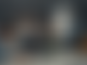 One person doing work, unrecognized, while the others laugh.