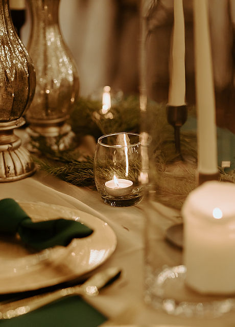 Details of candles, tabletop decor, plate, silverware at a wedding in a venue in central texas