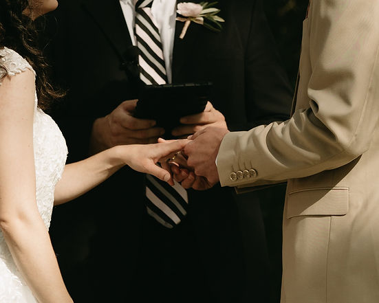 A wedding with a bride and groom exchanging rings at a wedding ceremony. At a Venue in Central Texas.