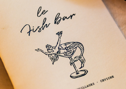 Rooftop of Fish Bar Essaouira with tables ready for booking a dinner with a sea view