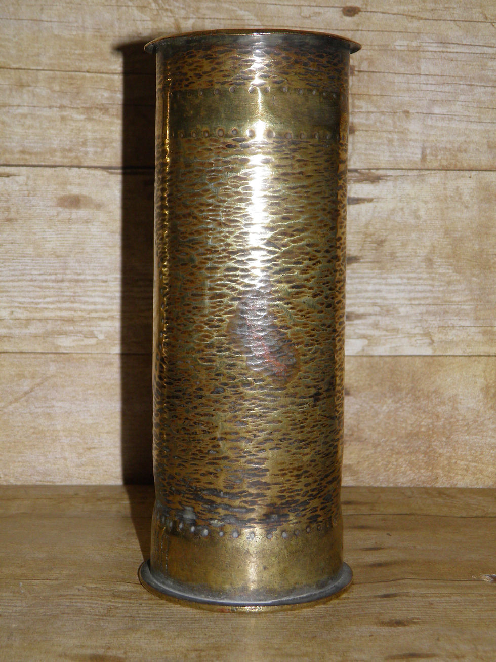 Thumbnail: This pair of antique military trench art solid brass canisters both feature different patterns The taller of the two features