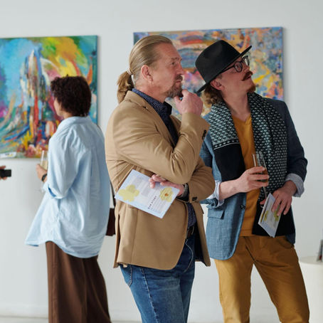 Art collector closely observing a textured abstract painting, highlighting the emotional and cultural factors that make an artwork valuable.
