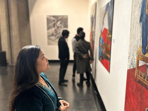 Employee taking a reflective moment in an office surrounded by calming artwork designed to support mental wellbeing and reduce stress.