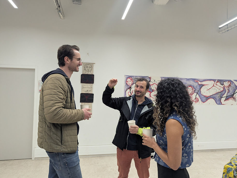 Contemporary artist discussing artwork with collectors inside a modern gallery space, highlighting authentic relationship-building in a sustainable art business.