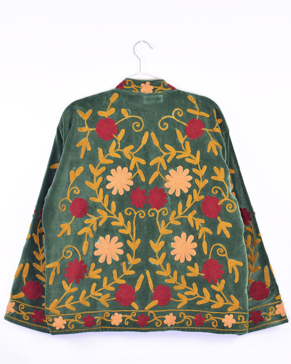 dark green velvet jacket with autumn colored flowers embroidered on it - back view