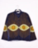 navy blue velvet jacket with green evil eyes embroidered around it