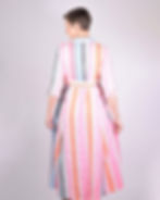 person wearing white, blue and neon striped dress - back view