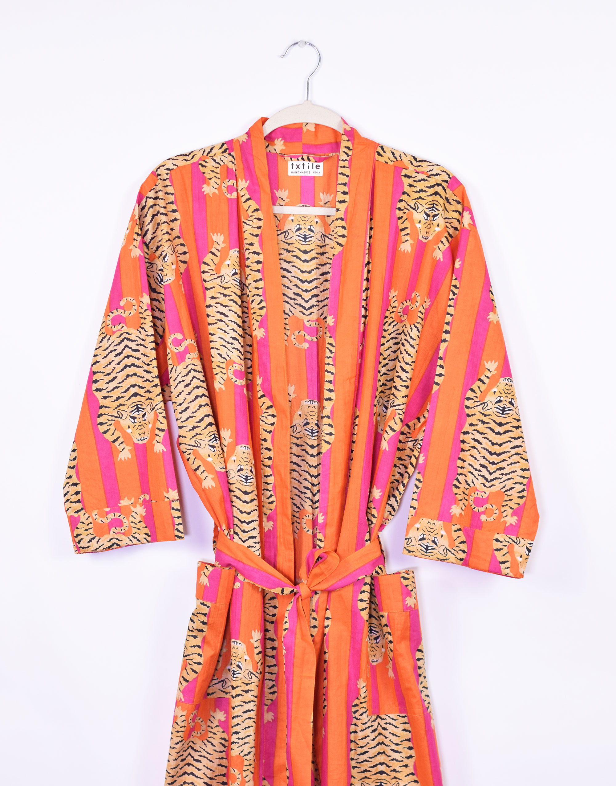pink and orange striped robe with tigers printed on it