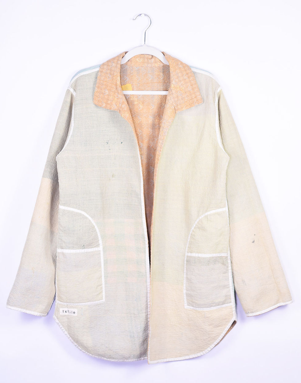 light colored long coat made of repurposed quilts