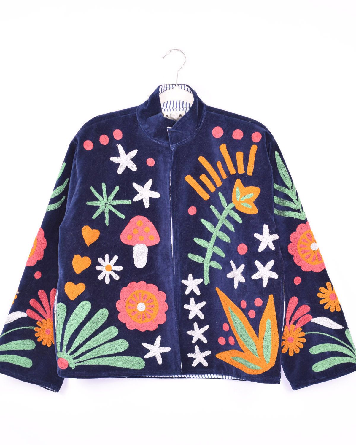 navy velvet jacket with whimsical design embroidered on it