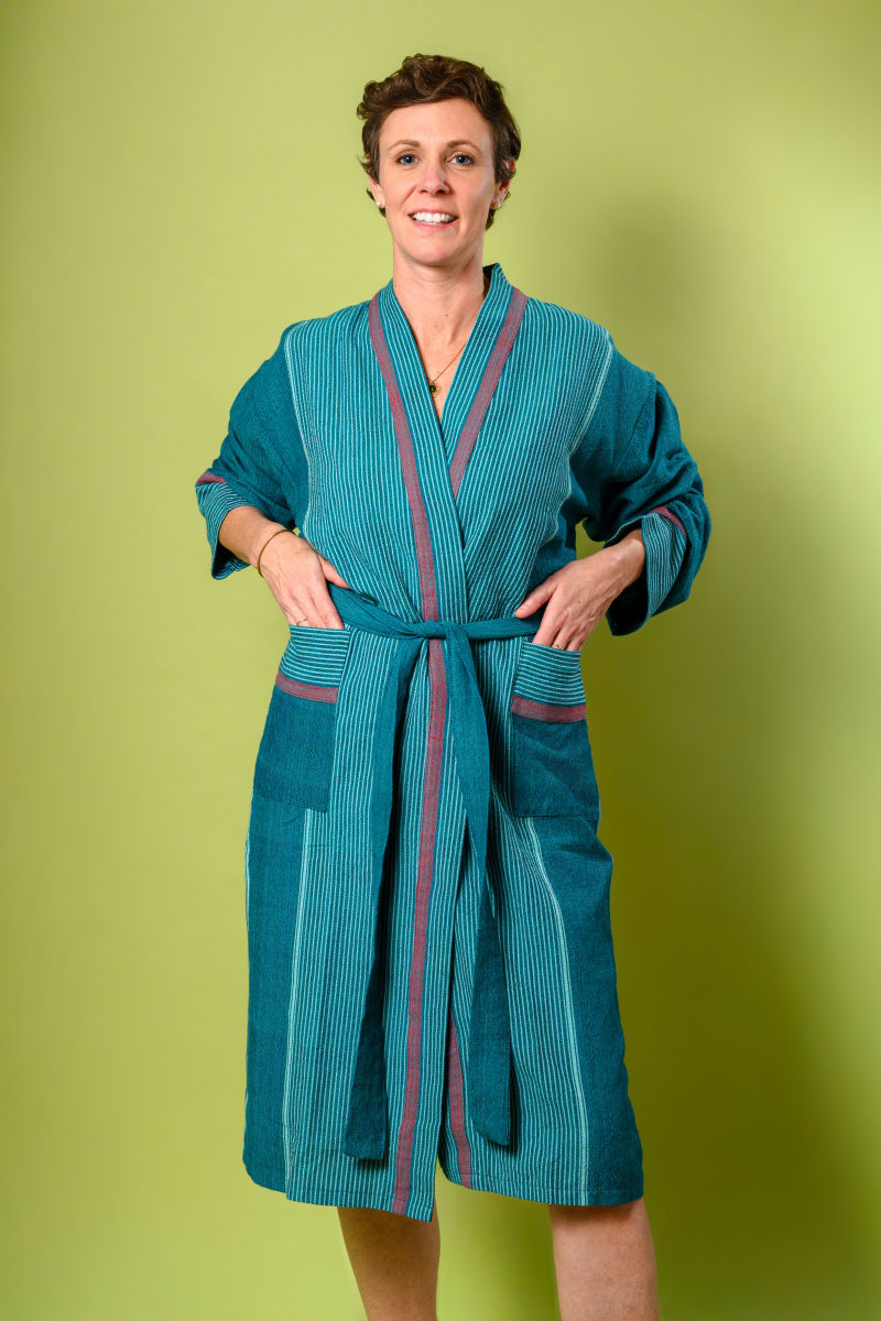 person wearing a luxury teal colored linen robe - zoom view
