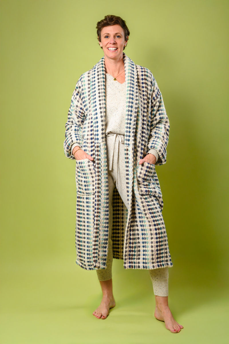 person wearing plush terry cloth robe with light colored checkers