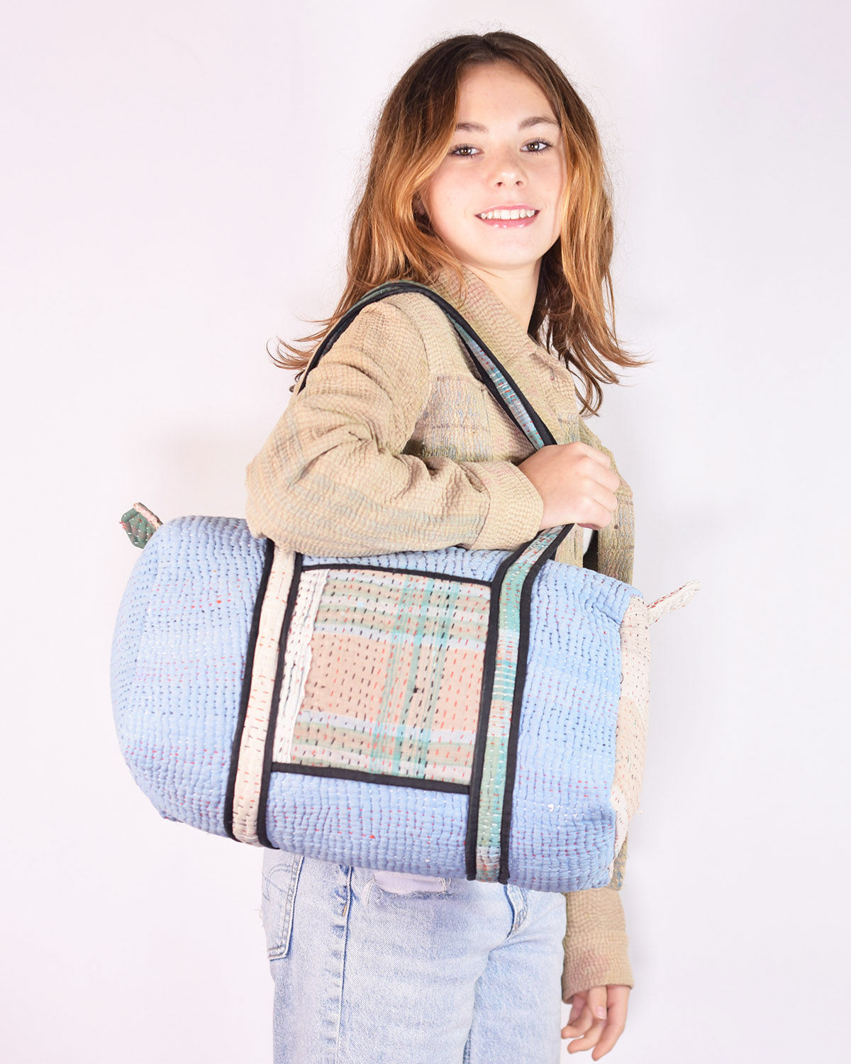 girl with blue mini tote bag made from repurposed quilts