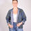 Thumbnail: Person wearing a denim jacket covered in mono chromatic embroidery - front view
