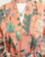 peach robe with safari animals printed on it