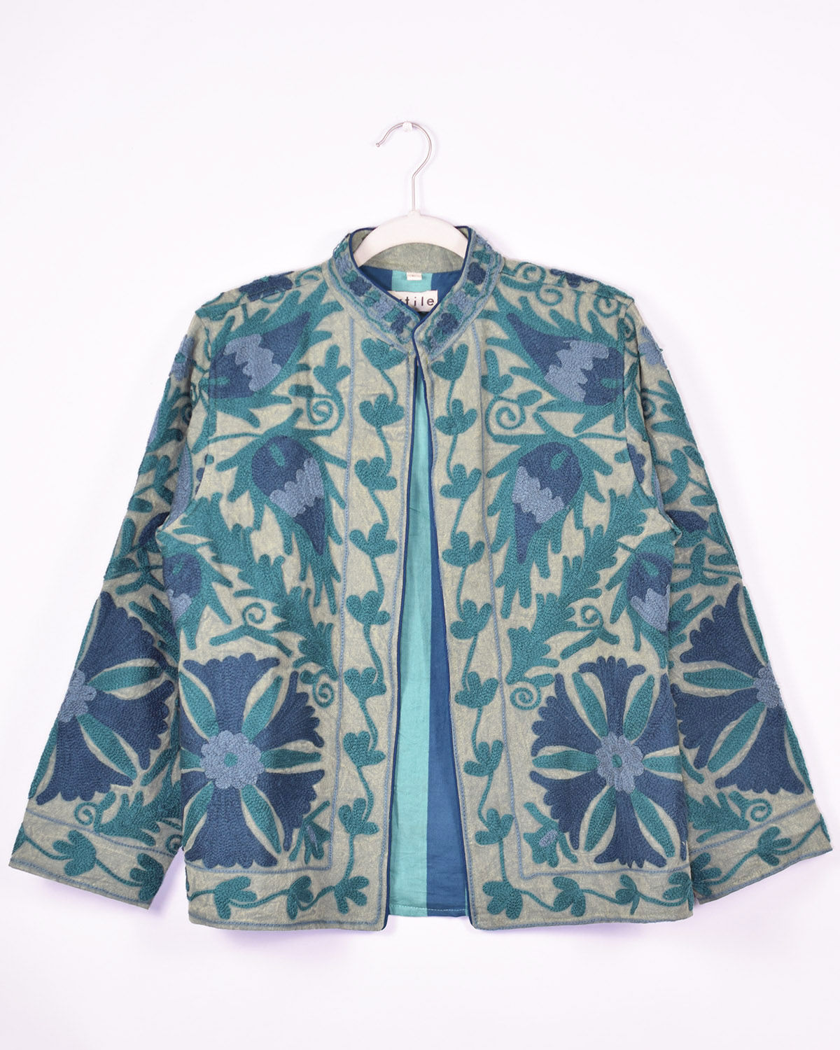 blue colored suzani embroidery over a soft blue canvas jacket