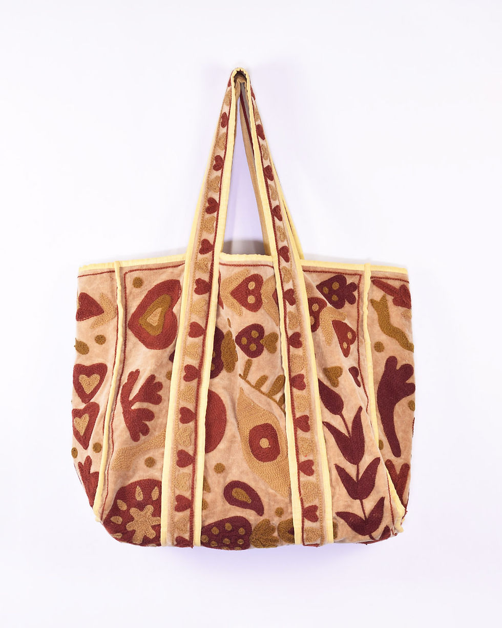 neutral velvet tote bag covered in whimsical embroidery - front view