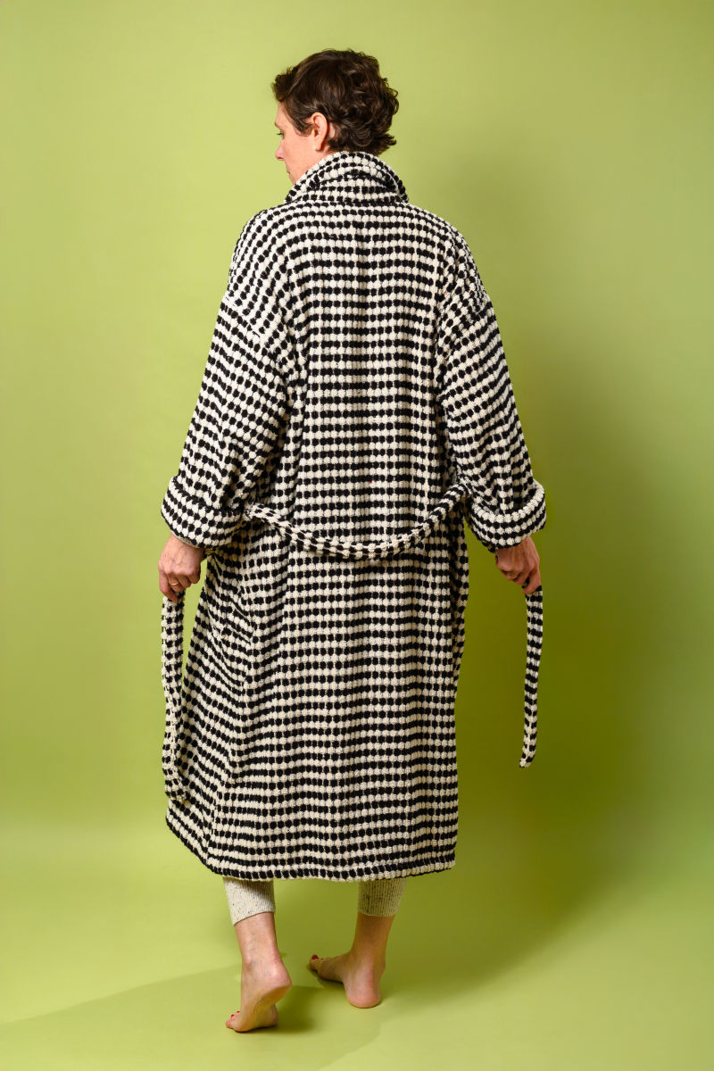 Person wearing black and white checkered terry cloth robe - back view