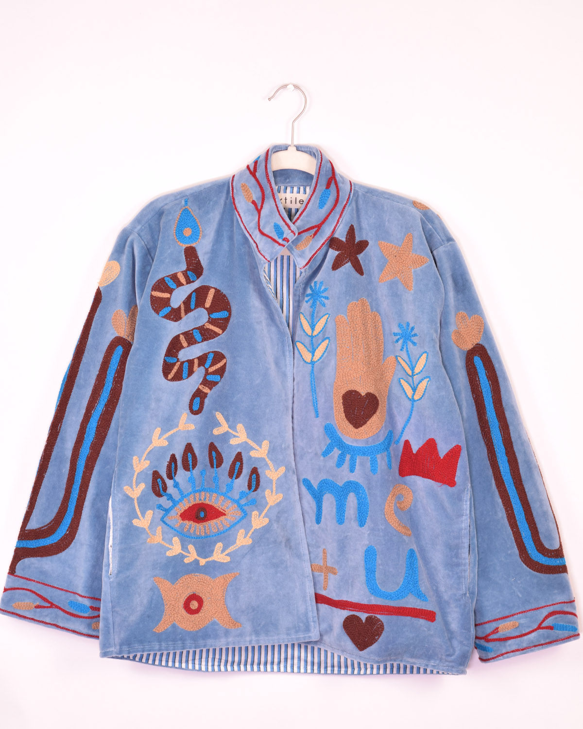 light blue velvet jacket covered in fun embroidery - front view