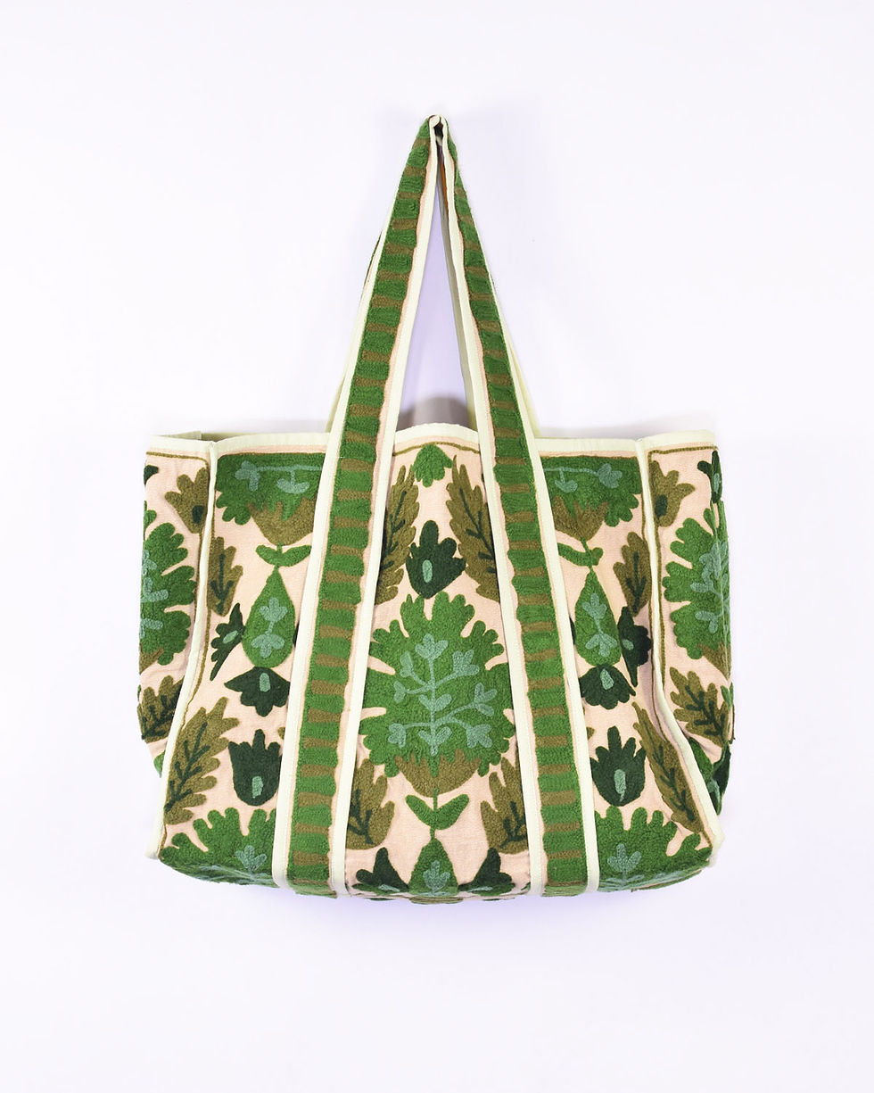 large canvas tote covered in green embroidery - front view