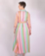 person wearing shirt dress made of a green and bright pink woven fabric - back view