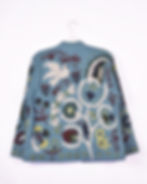 Back side of greyish blue canvas jacket with birds, hearts and flowers embroidered